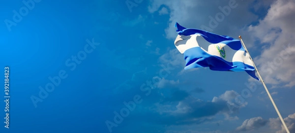 Fototapeta Beautiful national state flag of El Salvador with blank space. El Salvador flag on wide background with place for text 3D artwork.