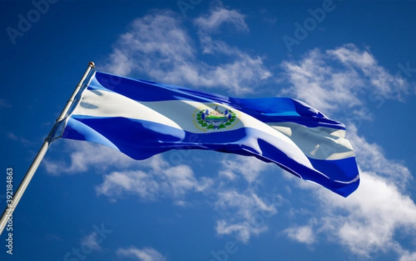 Fototapeta Beautiful national state flag of El Salvador fluttering at sky background. Low angle close-up El Salvador flag 3D artwork.