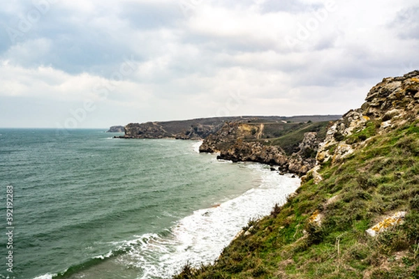 Obraz Mountains of steel and stones on the seashore. Wild beach. holidays, privacy,