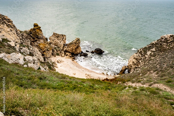 Obraz Mountains of steel and stones on the seashore. Wild beach. holidays, privacy,