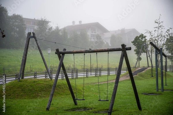 Fototapeta Empty children’s playground on a foggy summer morning