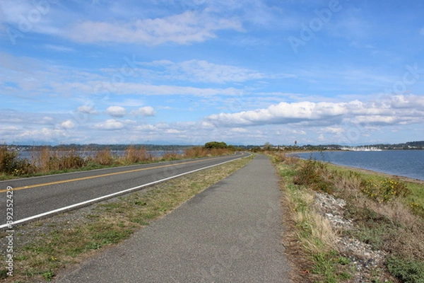 Fototapeta Semiahmoo Pkwy and a trail along the Semiahmoo Spit, shore on Semiahmoo Peninsula between Semiahmoo Bay and Drayton Harbor off the coast of Blaine 