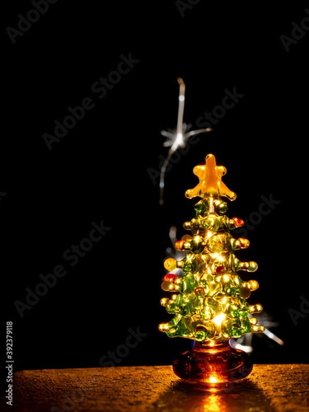 Obraz Glass Christmas tree with sparks in background