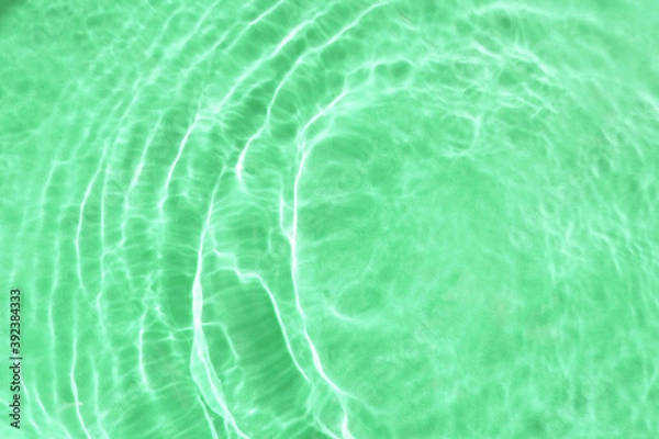 Fototapeta Realistic natural water wave overlay for background, blurred transparent green colored water surface texture with splashes and bubbles, trendy abstract background