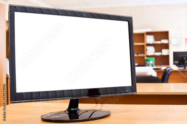 Fototapeta Computer monitor with isolated screen on desktop in office room