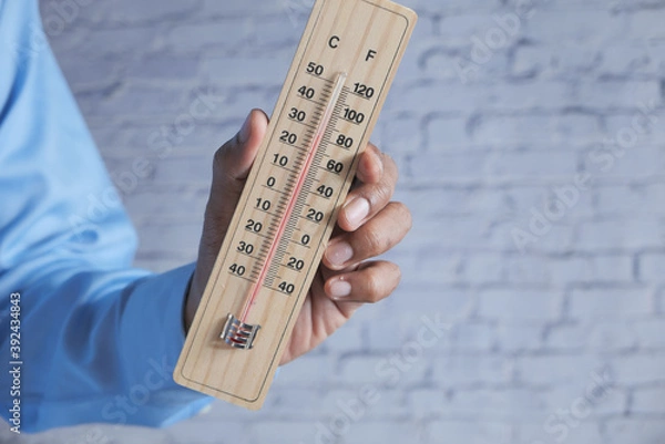 Fototapeta  hand holding Temperature measurement tools with copy space 