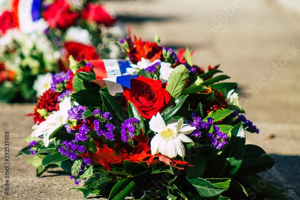 Obraz Closeup of wreath of flowers at the Armistice commemoration ceremony during the coronavirus epidemic and the lockdown to impose containment of the population