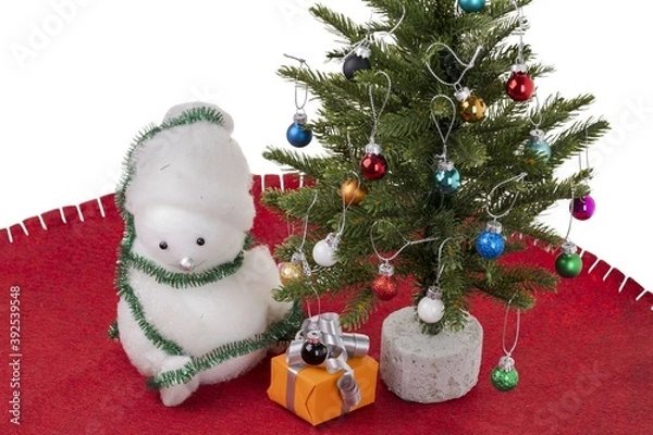 Fototapeta Close up view of christmas decoration objects on red carpet on white wall background. Christmas holiday concept.