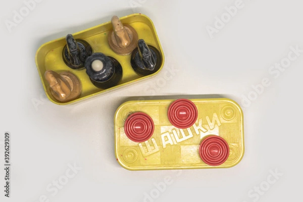 Fototapeta wooden chess pieces in a box of checkers