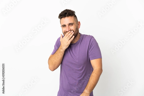 Fototapeta Caucasian man isolated on white background happy and smiling covering mouth with hand