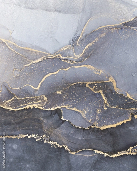 Fototapeta High resolution. Luxury abstract fluid art painting in alcohol ink technique, mixture of black, gray and gold paints. Imitation of marble stone cut, glowing golden veins. Tender and dreamy design.