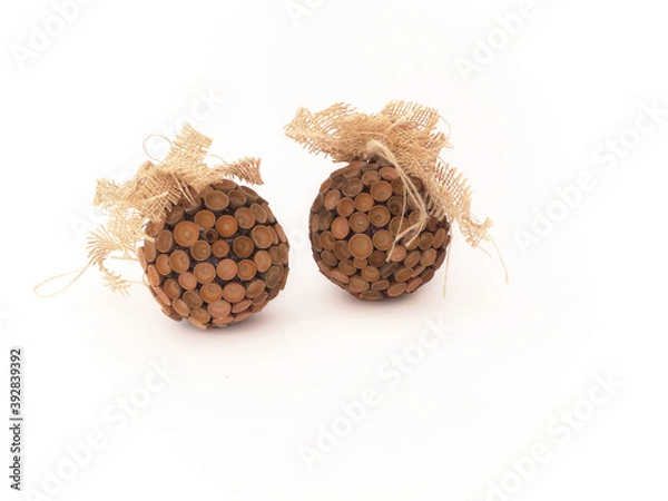 Fototapeta Christmas bauble decorated with acorn hats with jute material bow. Christmas balls made of acorns. Natural  materials ideal for making Christmas decorations. Rustic style. Natural Eco friendly Xmas. 