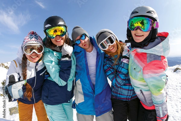 Fototapeta Group of friends snowboarders having fun on the top of mountain