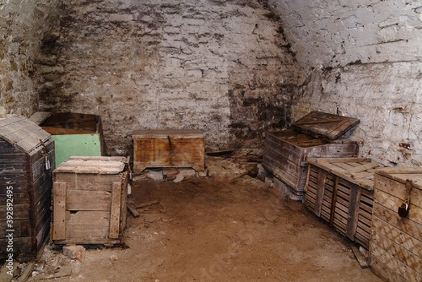 Fototapeta Chests and boxes in the basement of an old house. The picture was taken in Russia, in Orenburg