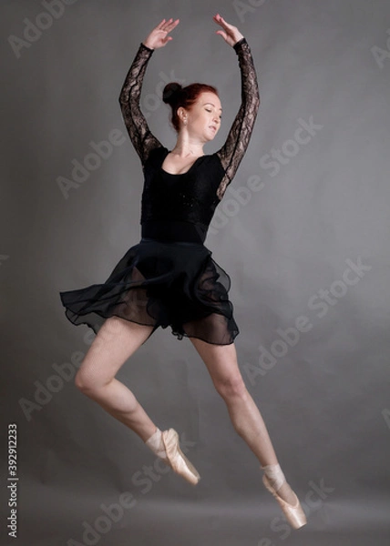 Fototapeta Beautiful dancer standing on grey background studio portrait.