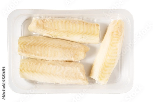 Obraz Frozen vacuum packed cod fish loins or fillets in plastic, isolated on white background.