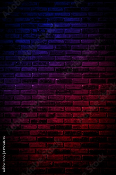 Fototapeta Neon light on brick walls that are not plastered background and texture. Lighting effect red and blue neon background vertical of empty brick basement wall.