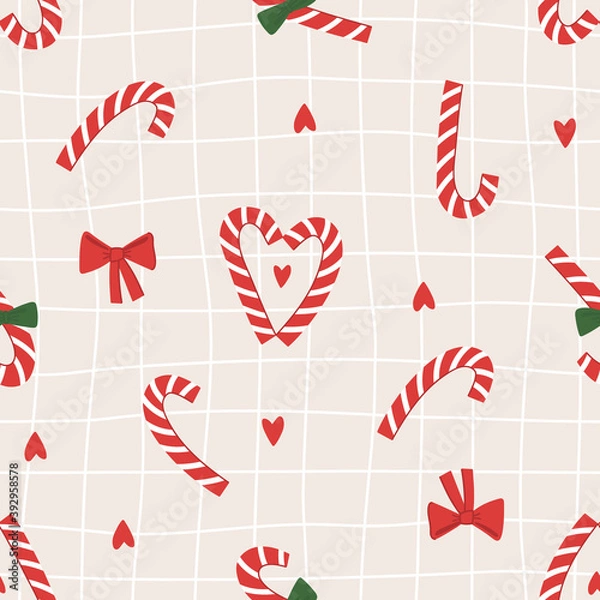 Fototapeta Seamless pattern of christmas red striped candies, red and green bows and red hearts in traditional christmas color. Hand drawn illustration in doodle style. For greeting card and another print design