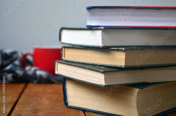 Fototapeta A stack of old books with yellowed pages, textbook, training, encyclopedia. Reading, knowledge. Library.