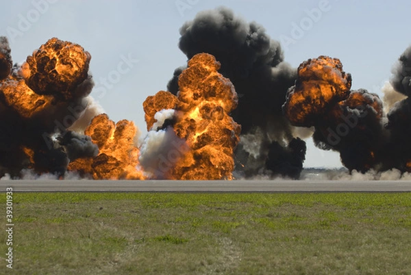 Fototapeta Multiple large explosions on airport runway