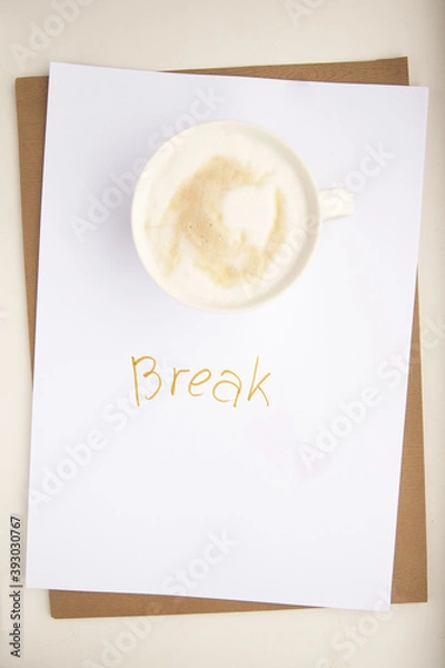Fototapeta A break during work. Time to rest. Cup of coffee on a white background with the inscription "break"