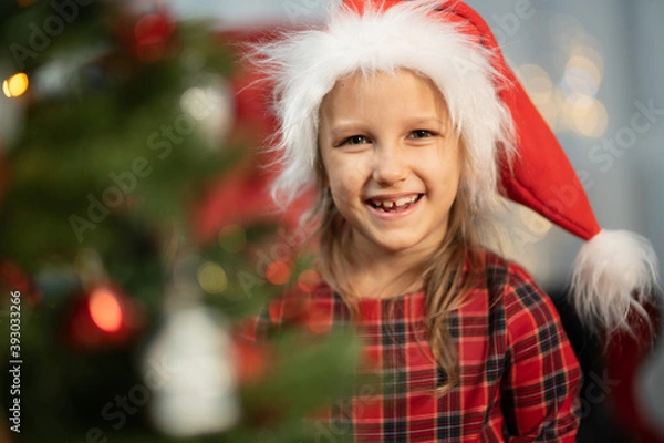 Fototapeta A child near a Christmas tree