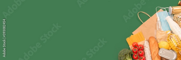 Obraz Banner with food and medicines donations on green background with copyspace - pasta, fresh vegatables, canned food, baguette, cooking oil. Food bank concept. Flat lay, selective focus