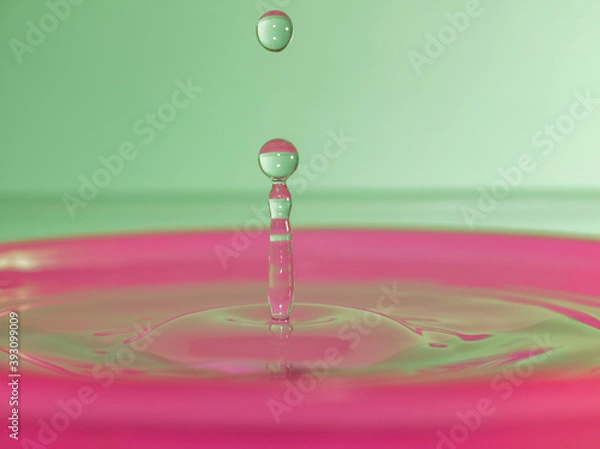 Fototapeta Column of water with two drops one in the air