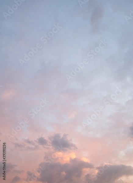Fototapeta sky in the evening with light red and clouds in different shades of grey