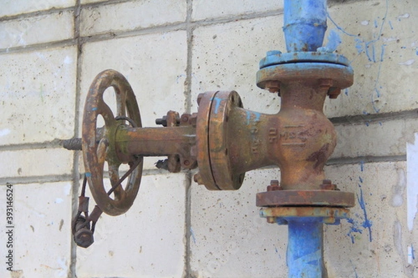 Obraz Old damaged and rusty iron oil pipe valve wheel. Metal, pipeline and mechanic concept. An old iron valve on a gas pipe. A valve to cover the pipe with a round handle