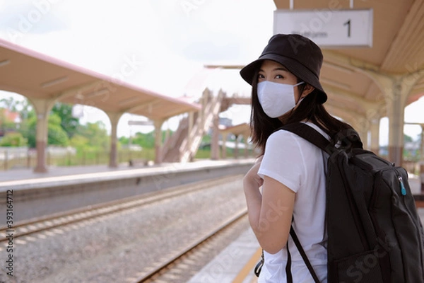Obraz woman with a backpack with mask , after pandemic traveling