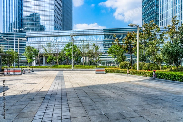 Fototapeta modern glass building exterior with empty pavement