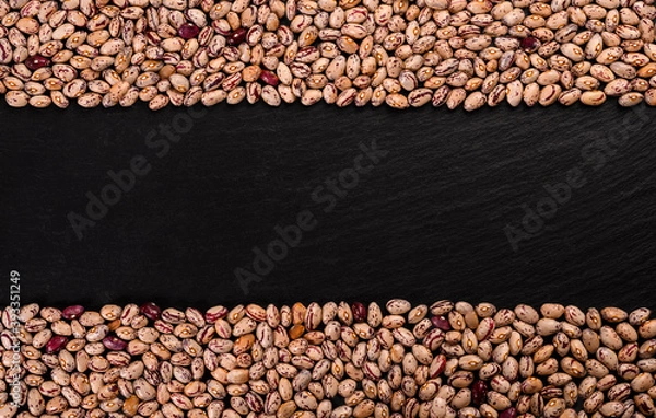 Obraz Coloren beans on black stone background.