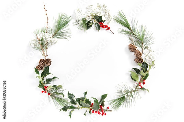 Fototapeta Christmas floral flat lay Frame ilex leaves red berries
