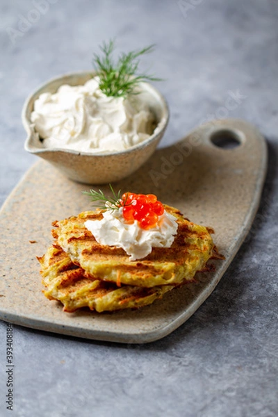 Fototapeta Hash Browns with Sour Cream, Dill and Red Caviar. Potato pancakes