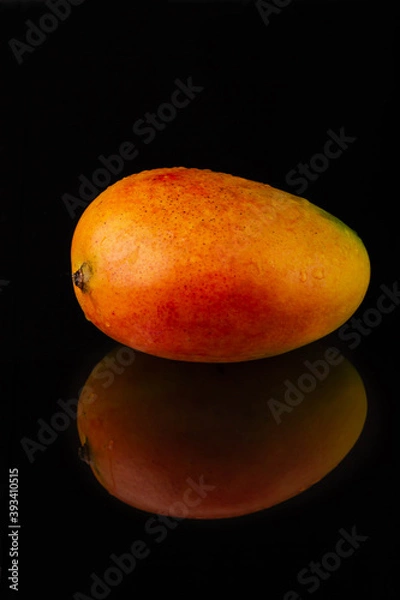 Fototapeta Fresh mango fruit on black background with reflection