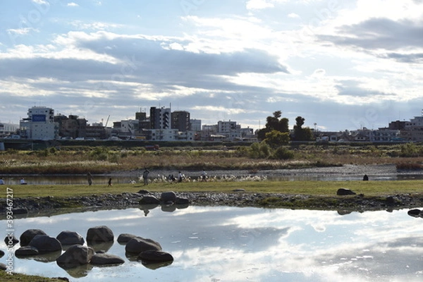 Fototapeta 川沿いで夕日を眺める