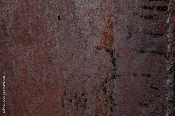 Fototapeta On a rough wall or floor, paint flakes off. Corrosion and rust of metal. Old dilapidated wall.
