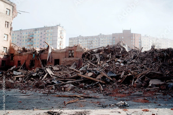 Fototapeta Blurred image Pile of demolition rubble. Gray rubble at a building site. Demolition of a house. Concrete rubble debris on construction site