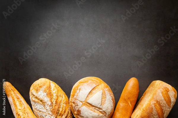 Fototapeta Assorted loaves of craft bread with copy space space for text