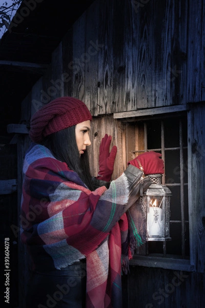 Fototapeta A frightened girl with a candlestick in her hand