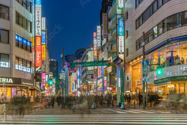 Fototapeta Night view of the crowd on the pedestrian crossing of the Sunshine 60 Street leading to the famous otome road decorated for the cebrations of the new year.