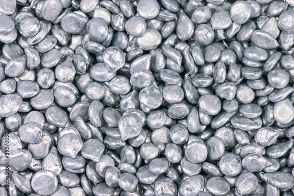 Fototapeta Pure zinc granules background for laboratory chemical experiments. .Zinc compounds are commonly used, such as dietary supplements, in deodorants, anti-dandruff shampoos, in luminescent paints.
