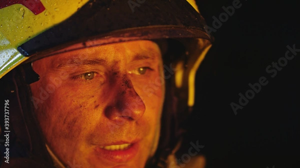 Fototapeta Portrait shot of a fireman in helmet. . High quality photo