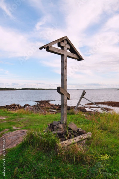 Fototapeta Close-up of a wooden Orthodox cross on a summer evening against the White sea, Russia.