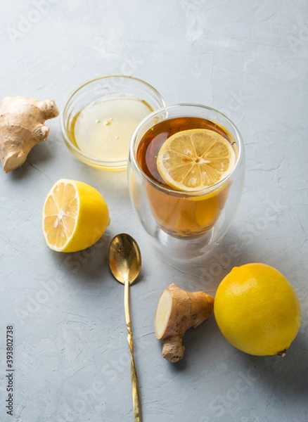 Obraz Healthy living herbal tea; lemon honey tea with ginger root on a gray background