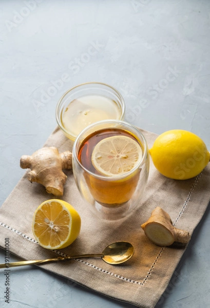 Fototapeta Healthy living herbal tea; lemon honey tea with ginger root on a gray background