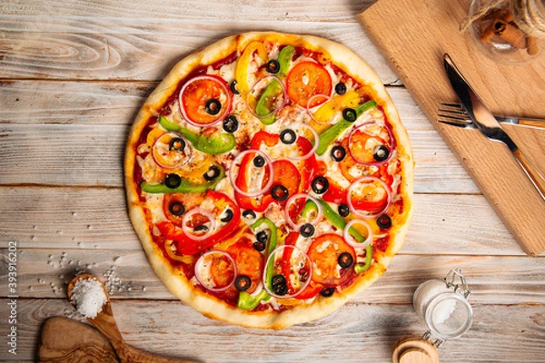 Fototapeta Top view on vegetable pizza with olives and pepper