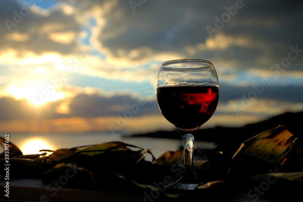 Fototapeta red wine in a glass at sunset,summer wine