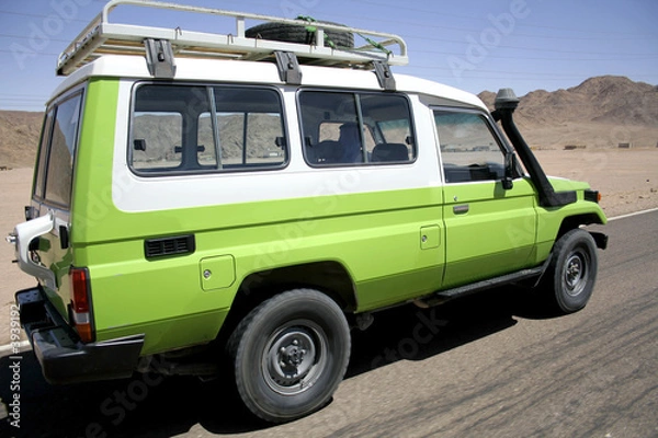 Fototapeta 4 wheel drive overtaking on a desert road in sinai, egypt